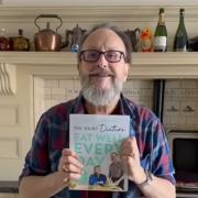 Dave Myers proudly holds his new book