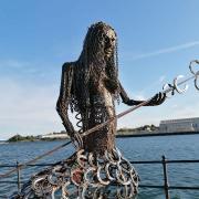 The 12-foot tall mermaid is made up of recyclable materials