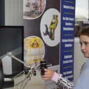 Freya Connor is a study in concention as she  successfully builds two blocks by operating a Kuka robot with a Haptic feedback control thanks to PAR Systems hands-on exhibit