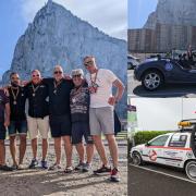 Team Gibraltar or Bust in front of the Rock of Gibraltar with friends from the rally, (pictured: the Banham Superbug and the Ghostbusters Volvo)