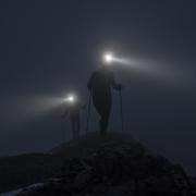 Walkers on the fells of Coniston lit only by head torches
