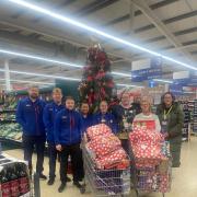 Tesco members and Family Action members with the toys received.