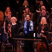 Conductor Domingo Hindoyan in a Barrow AFC scarf during the performance