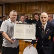 Millom's oldest surviving player and Vice Chairman Paul Roskell with the letters from King Charles and Rishi Sunak