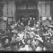 A crowd of people look back at the camera from the entrance of the new Salvation Army Hall in 1910