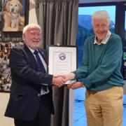 Anthony Robinson MBE being presented with his certificate by  John Dempster MBE