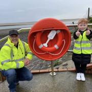 Cllr Paul Griffiths with his grandson Frankie outside the new lifebuoy