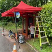 Duracoat workers restoring the vintage phone box at Rosside