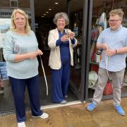 Re:new cuts the ribbon on its new shop and cafe (pictured from left to right: volunteer Lesley Hartley, Rev Doc Helen Hooley, Tim Jeffries)