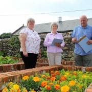 Ulverston in Bloom chair Kim Farr and Cumbria in Bloom judges Mary Wilson and John Thomson