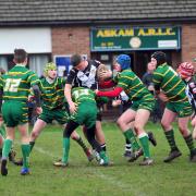GANGING UP: Askam under-14s' defence stop an opponent in their game against Saddleworth